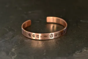 Guitar pick copper bracelet with cactus in a pot along with arrows